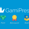 Blue background with white GamiPress logo at the center. Below, three icons: a green gem labeled "Points," a yellow medal with a red ribbon labeled "Achievements," and a blue shield with a star labeled "Ranks.